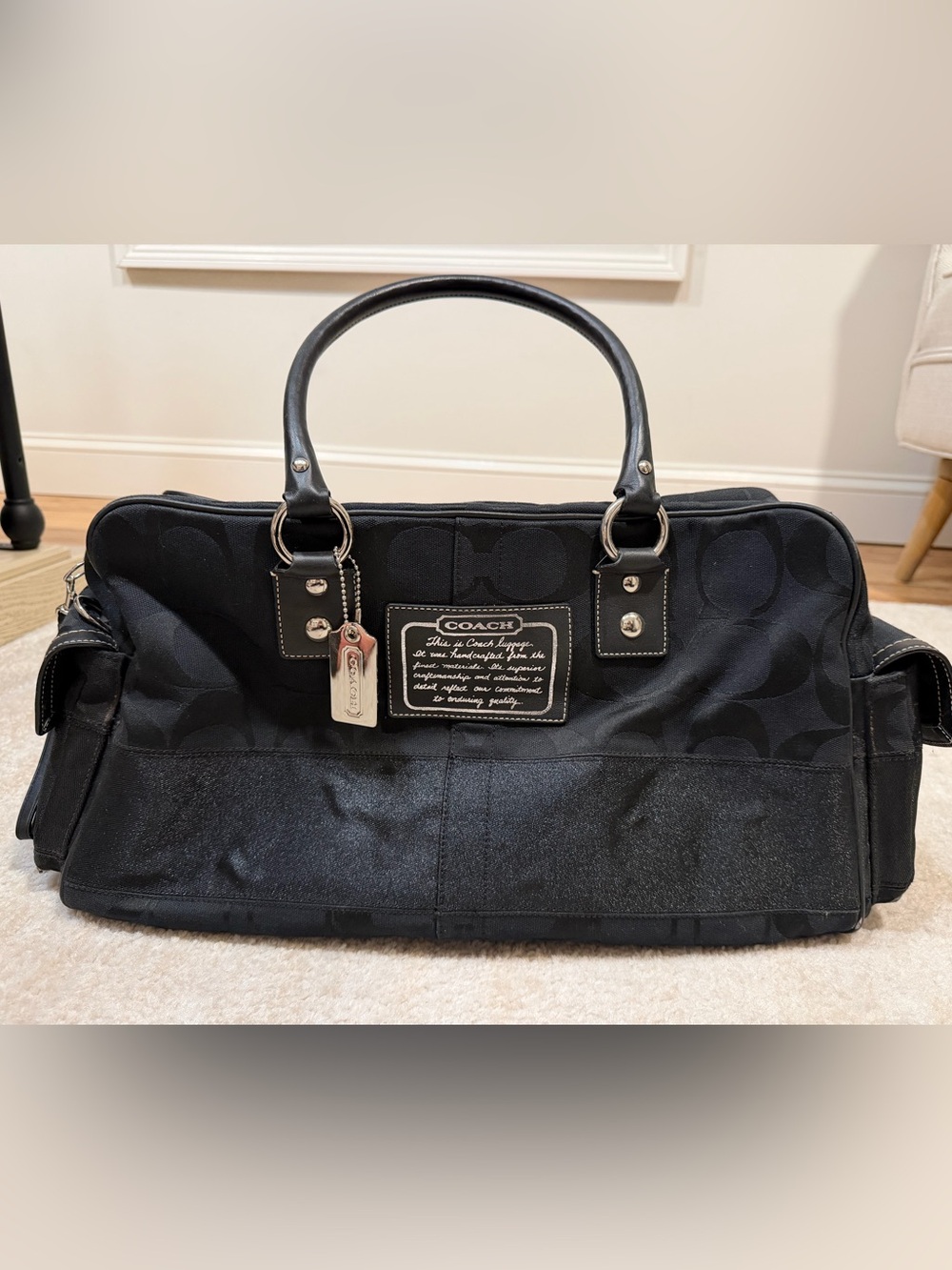 Coach Black Signature C Travel Bag with Silver Tags and Logo Patch